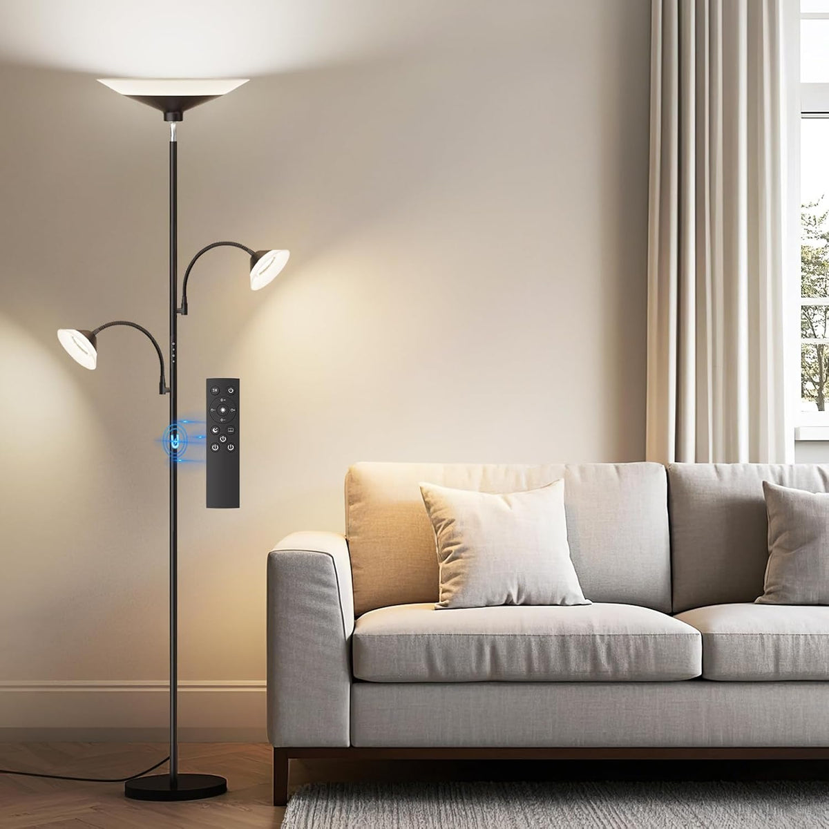 SIBRILLE 3-light torchiere floor lamp: black torchiere with two reading arms beside a sofa.