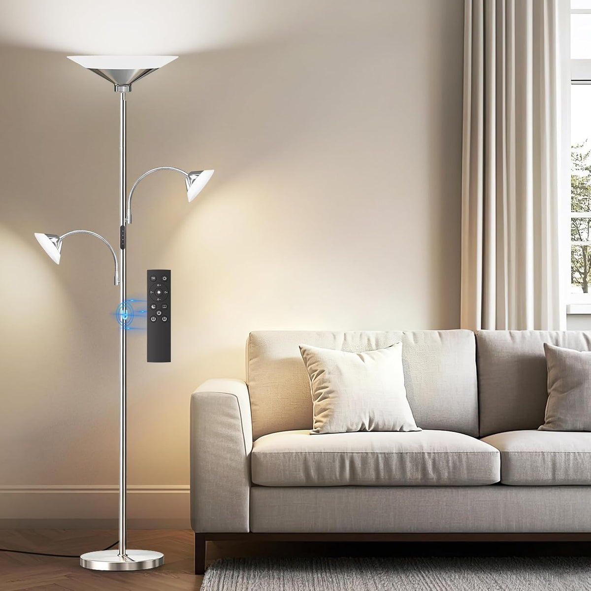SIBRILLE 3-light torchiere floor lamp: metallic silver torchiere with two reading arms beside a sofa.