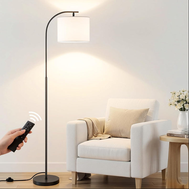 SIBRILLE arc floor lamp: white fabric shade on an arc lamp beside a chair.