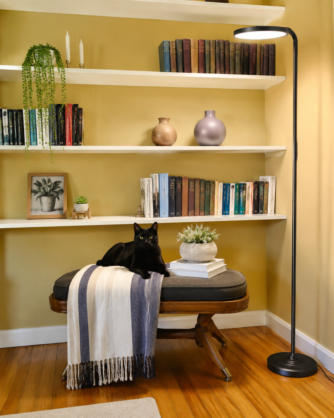 SIBRILLE 36W rotating floor lamp in a reading corner beside shelves and seating.