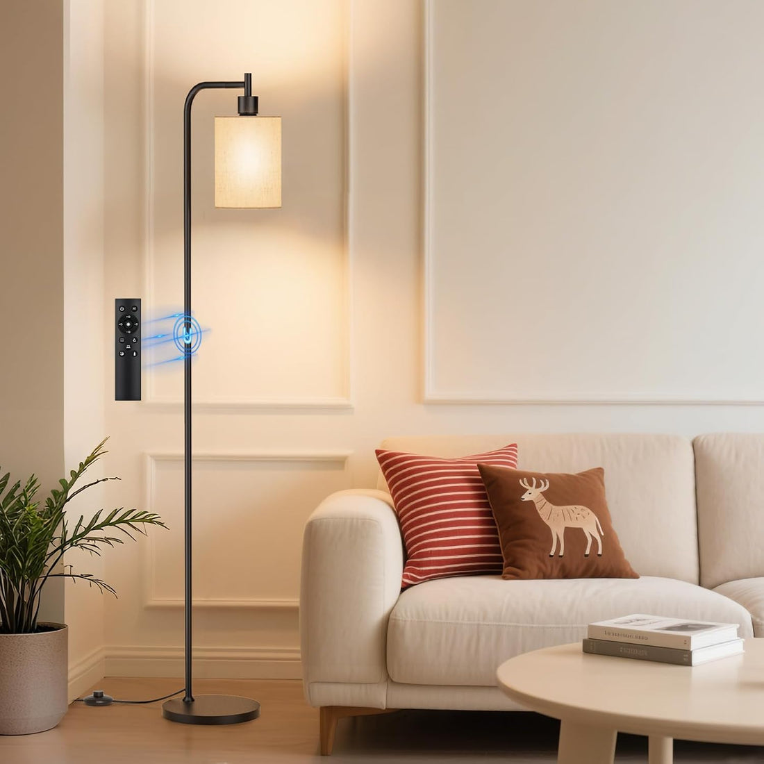 SIBRILLE fabric-shade floor lamp: fabric-shade floor lamp with remote beside a sofa.