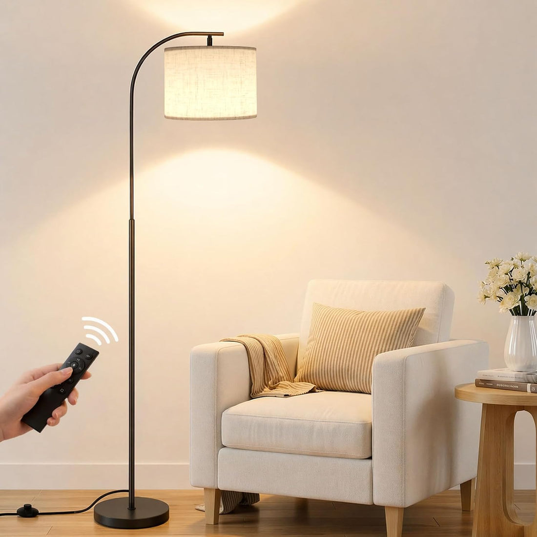 SIBRILLE arc floor lamp: curved black pole and fabric shade beside a reading chair.