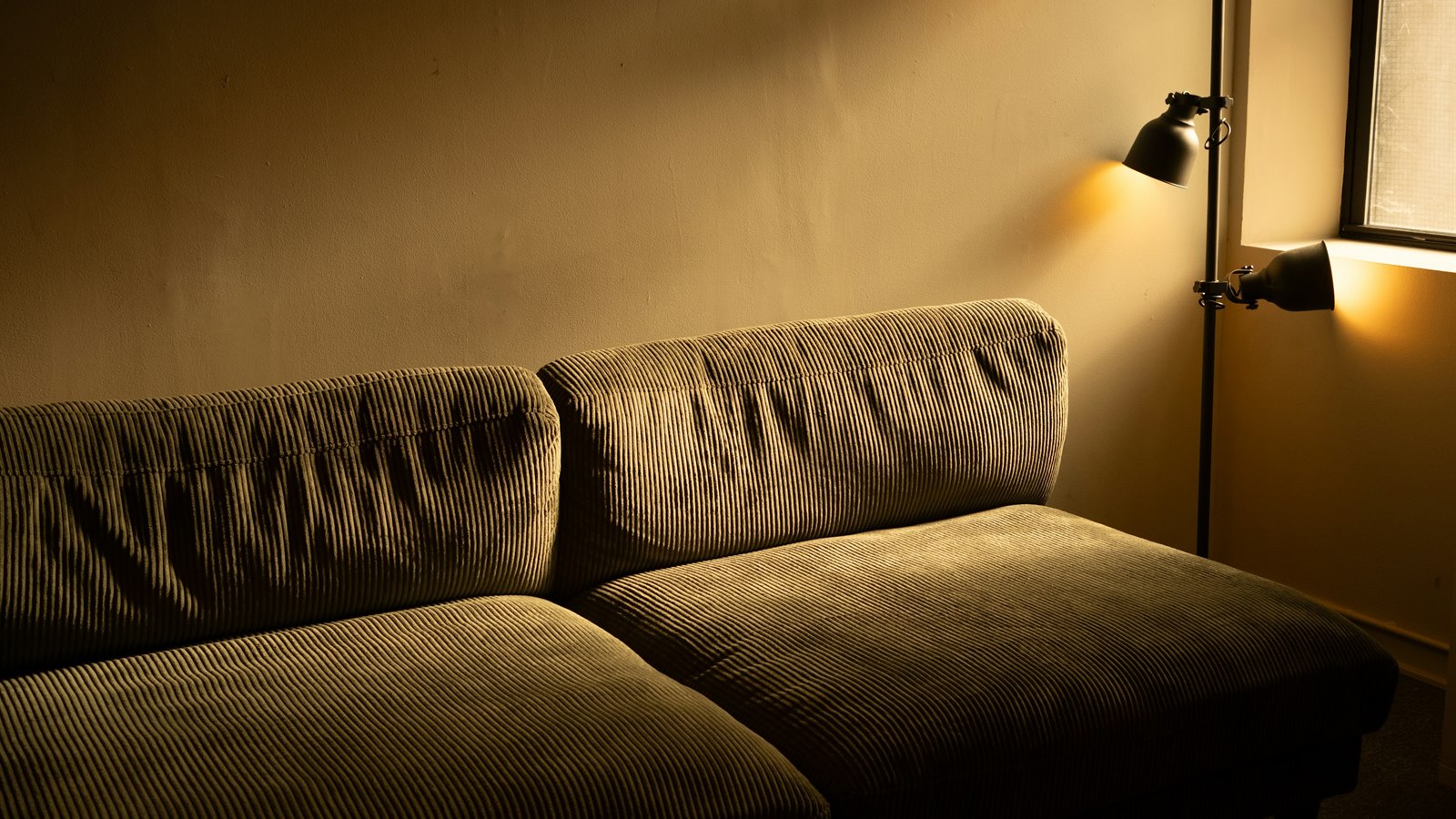 Living room floor lamp placement mistake beside a sofa